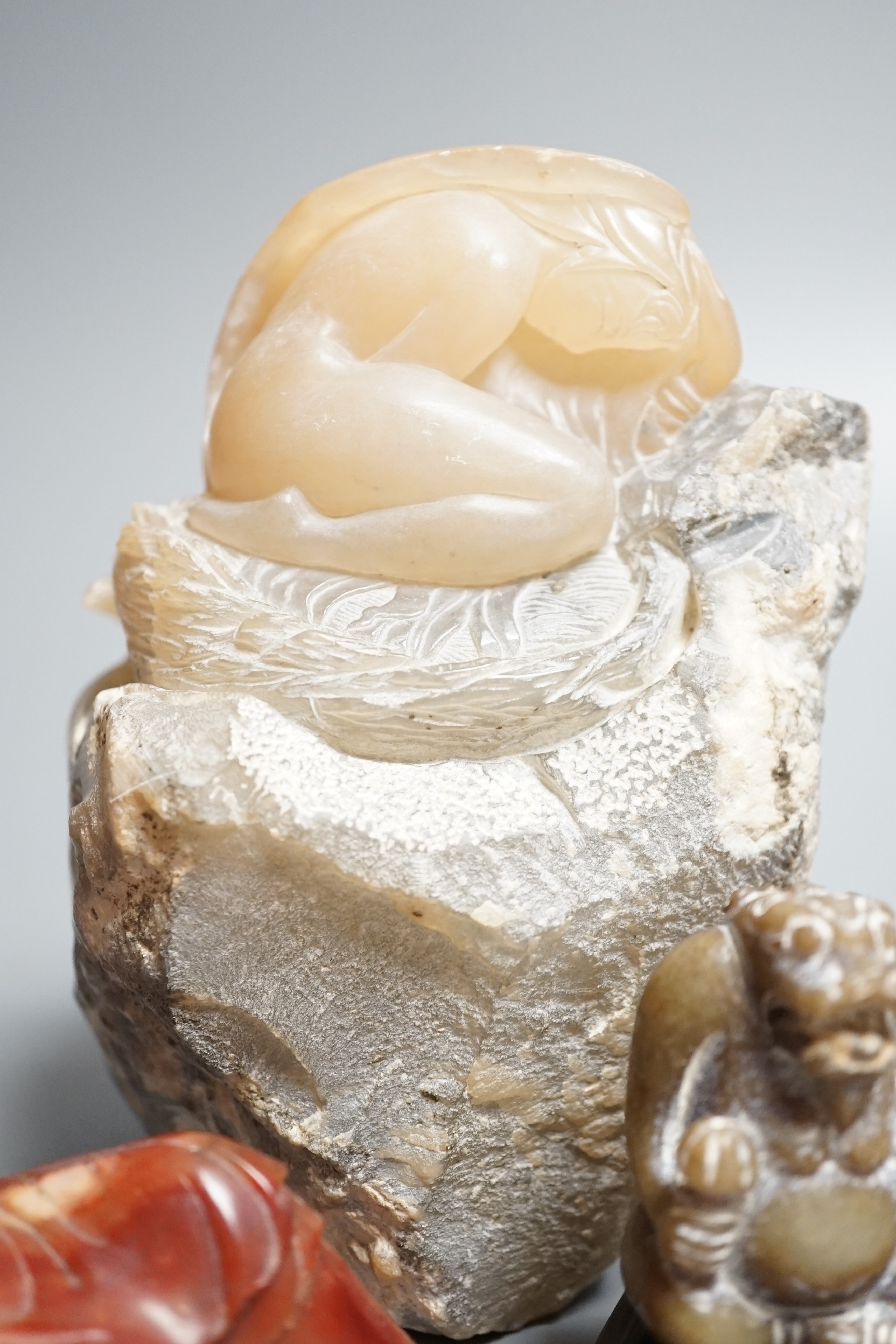 A Chinese jade figure of seated beast, possibly Han dynasty and four soapstone carvings, tallest 12cm